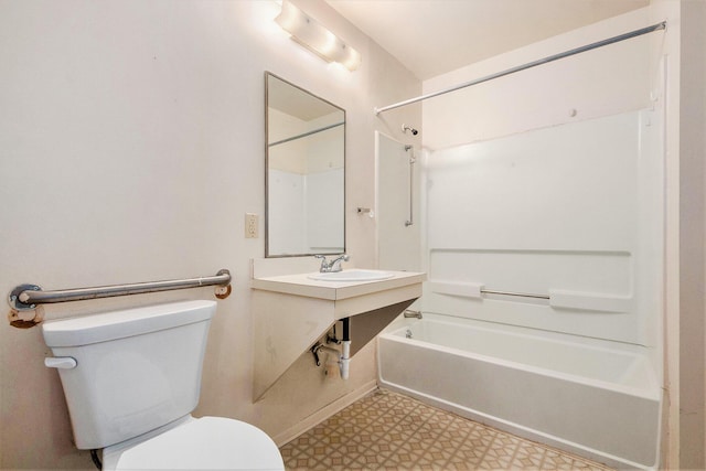 808 Woolsey Dr SW, Grand Rapids, MI 49503 - bathroom featuring tile patterned floors, toilet, bathtub / shower combination, and a sink