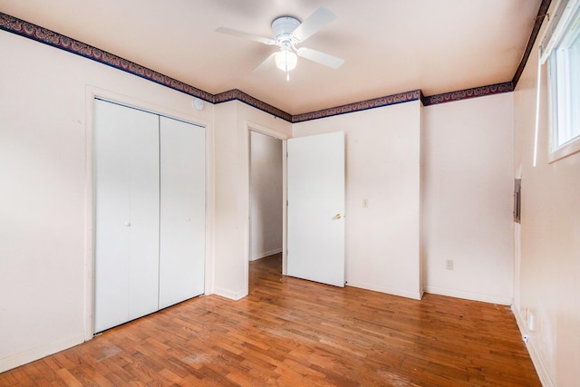 808 Woolsey Dr SW, Grand Rapids, MI 49503 - unfurnished bedroom featuring wood finished floors, a closet, ceiling fan, and baseboards