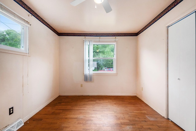 808 Woolsey Dr SW, Grand Rapids, MI 49503 - spare room with wood finished floors, ceiling fan, and baseboards