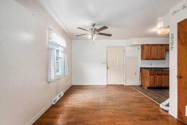808 Woolsey Dr SW, Grand Rapids, MI 49503 - kitchen featuring brown cabinetry, ceiling fan, dark wood-style floors, and dark countertops