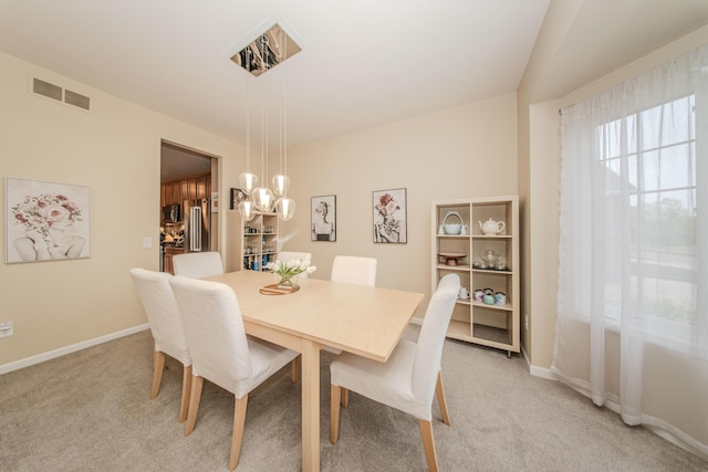 57677 Blossom Valley Trl, New Hudson, MI 48165 - dining space featuring light colored carpet, baseboards, and a chandelier