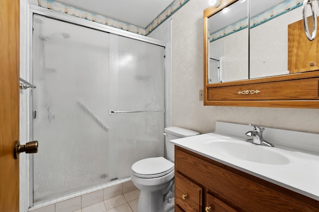 8118 Bruning St, Portage, MI 49002 - bathroom with a shower stall, toilet, tile patterned floors, and vanity