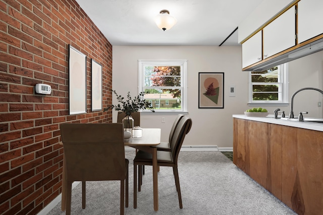 8118 Bruning St, Portage, MI 49002 - dining room with light carpet, brick wall, a baseboard heating unit, and baseboards