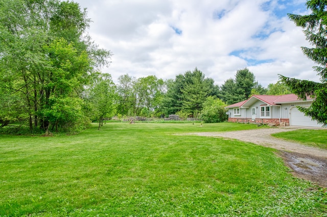4384 Dexter Pinckney Rd, Dexter, MI 48130 - view of grassy yard with driveway and an attached garage