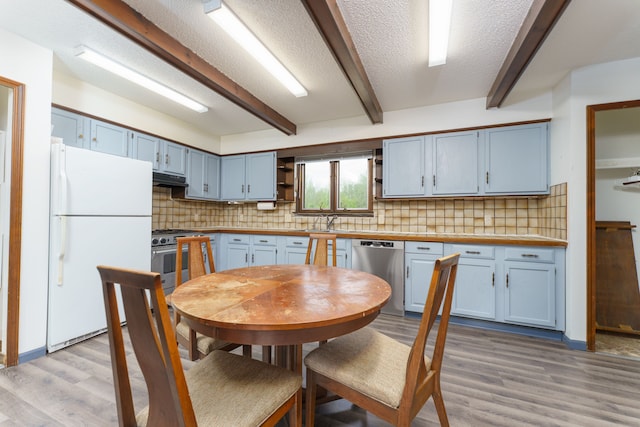 4384 Dexter Pinckney Rd, Dexter, MI 48130 - kitchen featuring stainless steel appliances, blue cabinetry, light wood finished floors, beamed ceiling, and tasteful backsplash