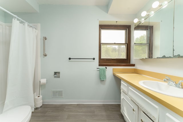 4384 Dexter Pinckney Rd, Dexter, MI 48130 - full bath featuring wood finished floors, toilet, vanity, baseboards, and curtained shower