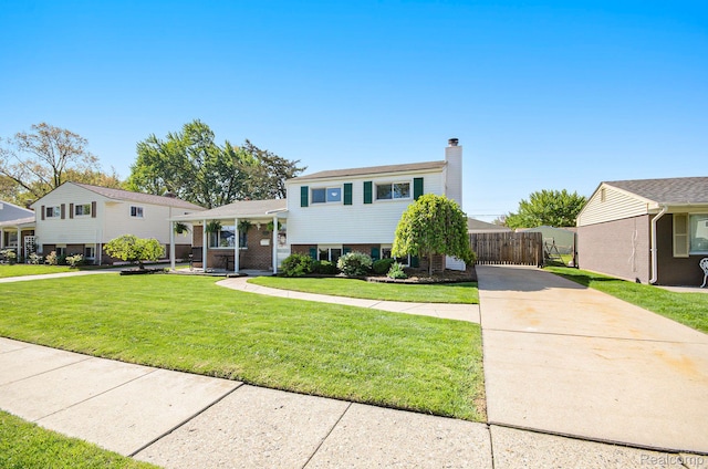 2426 Camel Dr, Sterling Heights, MI 48310 - tri-level home with a chimney, driveway, and brick siding