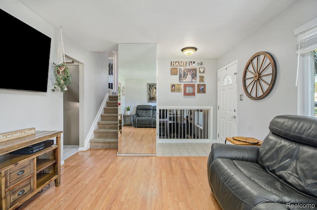 2426 Camel Dr, Sterling Heights, MI 48310 - living area featuring light wood-style floors, stairs, and baseboards