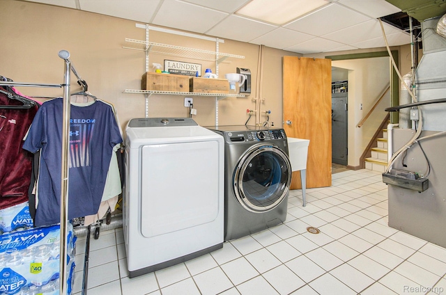 2426 Camel Dr, Sterling Heights, MI 48310 - laundry area with washing machine and dryer and tile patterned flooring