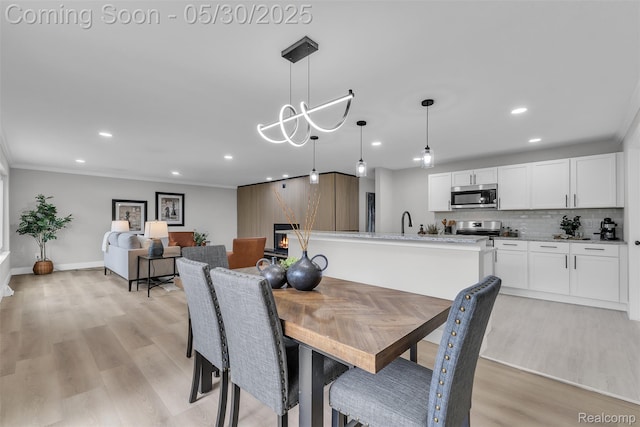 22929 Wrexford Dr, Southfield, MI 48033 - dining room featuring recessed lighting, light wood-style flooring, baseboards, crown molding, and a chandelier