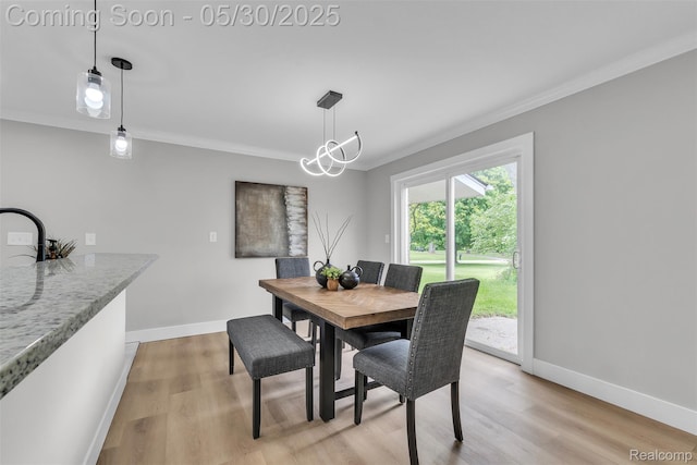 22929 Wrexford Dr, Southfield, MI 48033 - dining area with crown molding, baseboards, and light wood finished floors