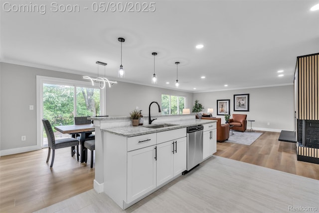 22929 Wrexford Dr, Southfield, MI 48033 - kitchen featuring a sink, stainless steel dishwasher, ornamental molding, baseboards, and light stone countertops