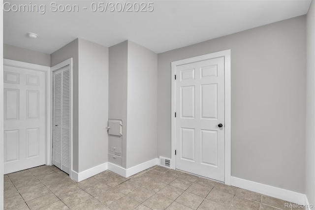 22929 Wrexford Dr, Southfield, MI 48033 - unfurnished bedroom featuring a closet, baseboards, and light tile patterned flooring