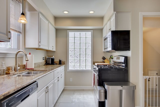 kitchen featuring appliances with stainless steel finishes, a sink, white cabinets, and recessed lighting