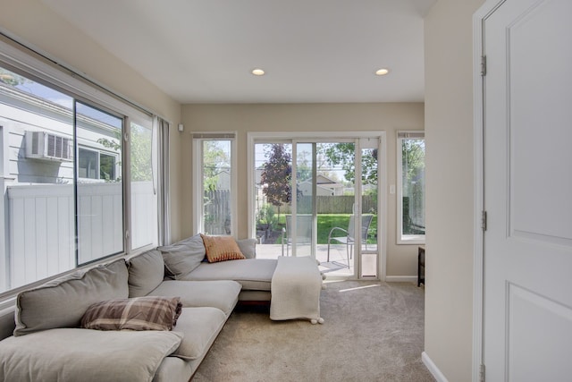 living area featuring carpet floors, recessed lighting, baseboards, and cooling unit