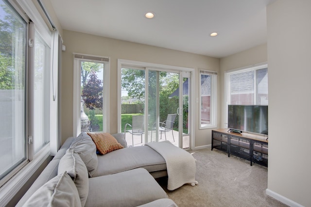 living area featuring light colored carpet, baseboards, and recessed lighting