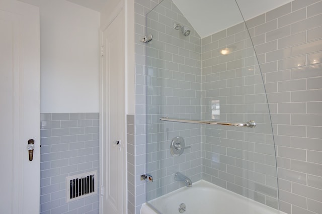 full bathroom featuring shower / bath combination and lofted ceiling