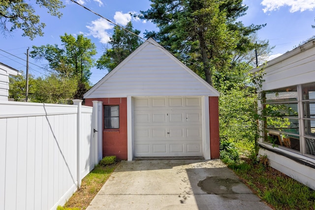 detached garage with concrete driveway