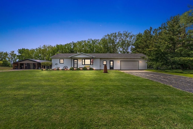 19354 Bueche Rd, New Lothrop, MI 48460 - ranch-style house with an attached garage, asphalt driveway, and a front yard