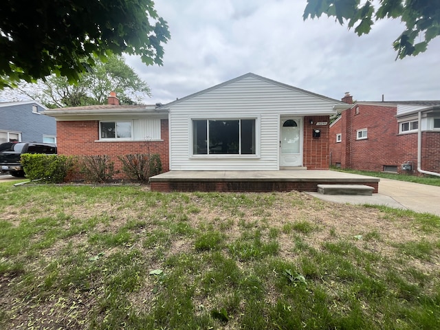 15255 Mulberry St, Southgate, MI 48195 - view of front of house with brick siding, a chimney, and a front yard
