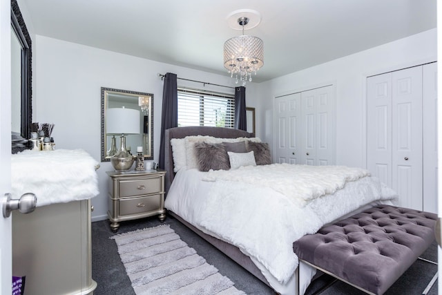 38554 Lanse Creuse St, Harrison Township, MI 48045 - bedroom with two closets, dark colored carpet, baseboards, and a chandelier