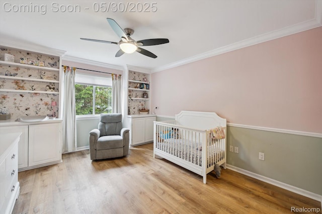 326 Redmaple Ln, Brighton, MI 48116 - bedroom featuring a crib, ornamental molding, light wood-type flooring, ceiling fan, and baseboards