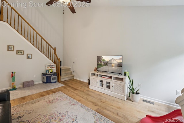 326 Redmaple Ln, Brighton, MI 48116 - living room with stairway, a ceiling fan, wood finished floors, and baseboards