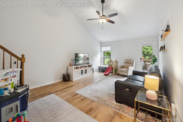 326 Redmaple Ln, Brighton, MI 48116 - living room with ceiling fan, wood finished floors, baseboards, high vaulted ceiling, and stairs