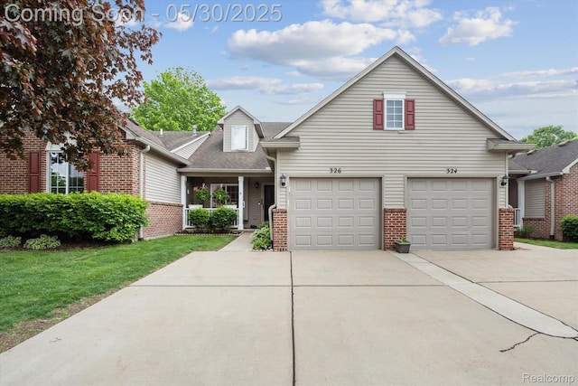 326 Redmaple Ln, Brighton, MI 48116 - traditional-style house featuring brick siding, concrete driveway, a front lawn, and a garage