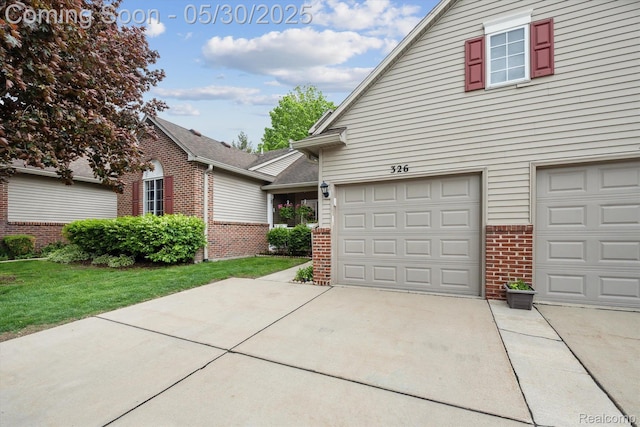 326 Redmaple Ln, Brighton, MI 48116 - traditional home with brick siding, driveway, a front lawn, and a garage