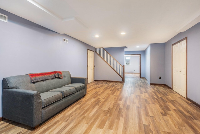 10191 84th St SE, Alto, MI 49302 - living area featuring light wood-style floors, baseboards, stairway, and recessed lighting
