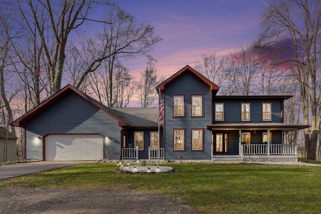 10191 84th St SE, Alto, MI 49302 - view of front facade featuring a porch, an attached garage, asphalt driveway, and a front lawn