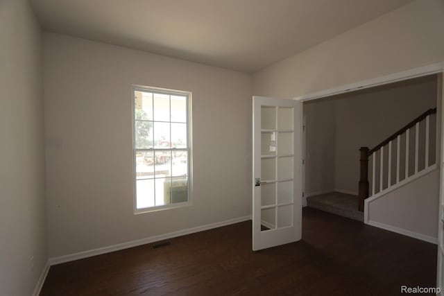 27144 Silo Dr, Saline, MI 48176 - empty room featuring wood finished floors, stairway, and french doors