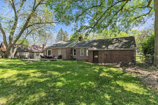 3418 Fieldview Ave, West Bloomfield, MI 48324 - rear view of house with brick siding and a chimney