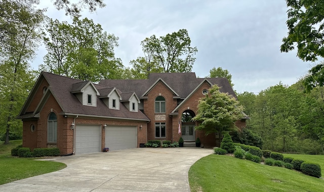 4181 Pavilion Ct, Fenton, MI 48430 - view of front facade featuring brick siding, concrete driveway, a front yard, french doors, and roof with shingles