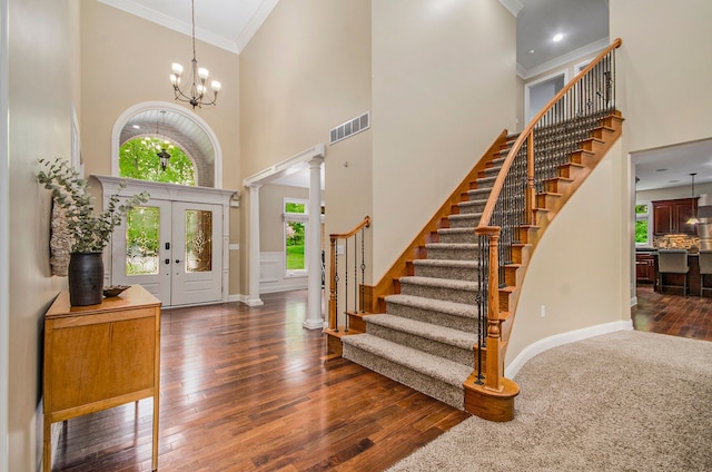 4181 Pavilion Ct, Fenton, MI 48430 - entrance foyer with a towering ceiling, stairway, baseboards, ornamental molding, and decorative columns