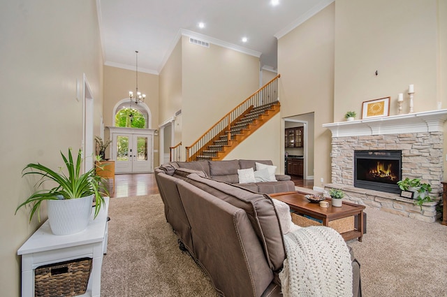 4181 Pavilion Ct, Fenton, MI 48430 - living area with a fireplace, a towering ceiling, crown molding, french doors, and a chandelier
