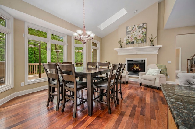 4181 Pavilion Ct, Fenton, MI 48430 - dining room featuring a chandelier, healthy amount of natural light, a glass covered fireplace, and high vaulted ceiling