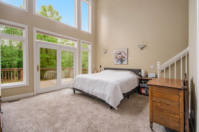 4181 Pavilion Ct, Fenton, MI 48430 - bedroom featuring access to exterior, a high ceiling, carpet flooring, and baseboards