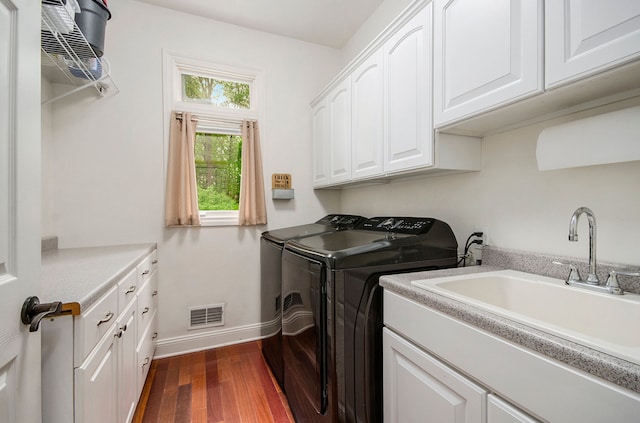4181 Pavilion Ct, Fenton, MI 48430 - laundry room with cabinet space, separate washer and dryer, dark wood-type flooring, and baseboards