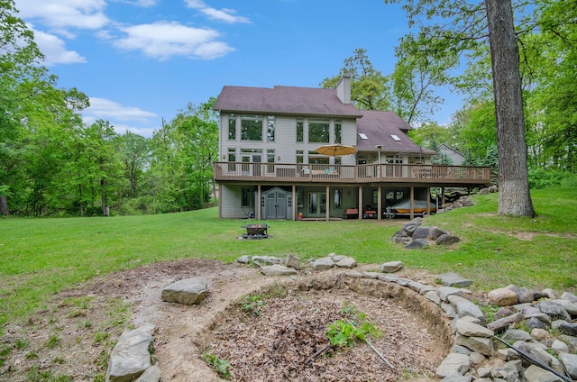 4181 Pavilion Ct, Fenton, MI 48430 - back of property featuring an outdoor fire pit, a deck, a yard, and a chimney