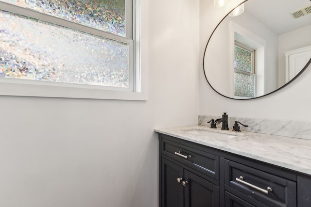 bathroom featuring healthy amount of natural light and vanity
