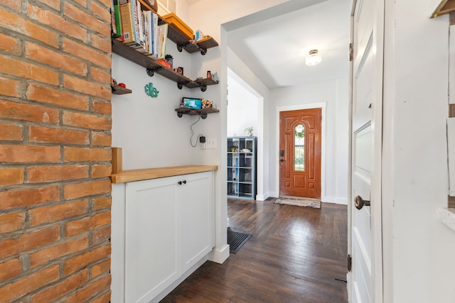 entrance foyer featuring dark wood-style floors and baseboards