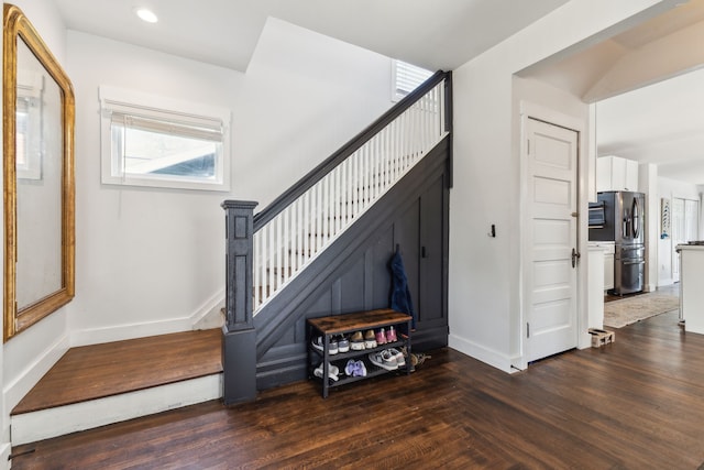 staircase with baseboards, recessed lighting, and wood finished floors