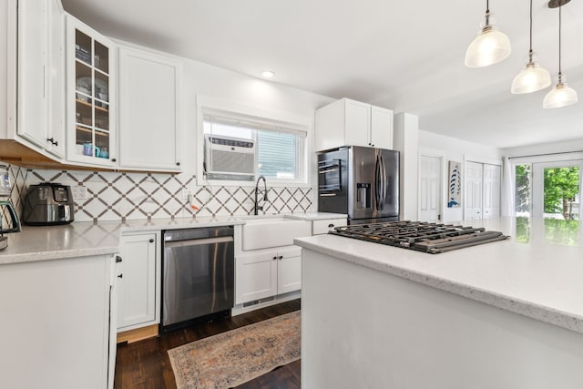 kitchen featuring stainless steel appliances, a sink, backsplash, white cabinets, and recessed lighting