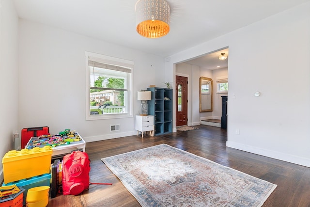 game room with healthy amount of natural light, baseboards, and wood finished floors