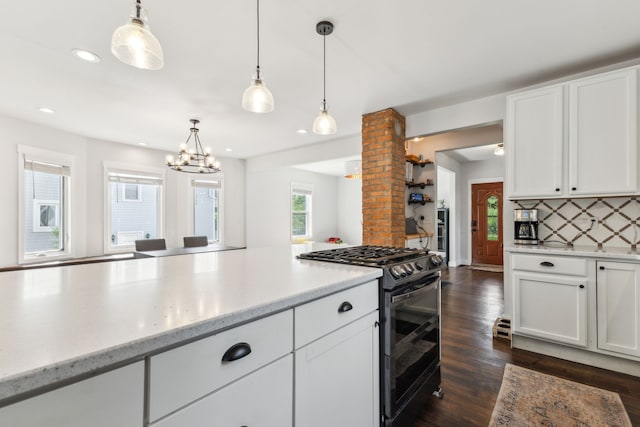 kitchen with black gas stove, decorative backsplash, white cabinetry, dark wood-style flooring, and pendant lighting