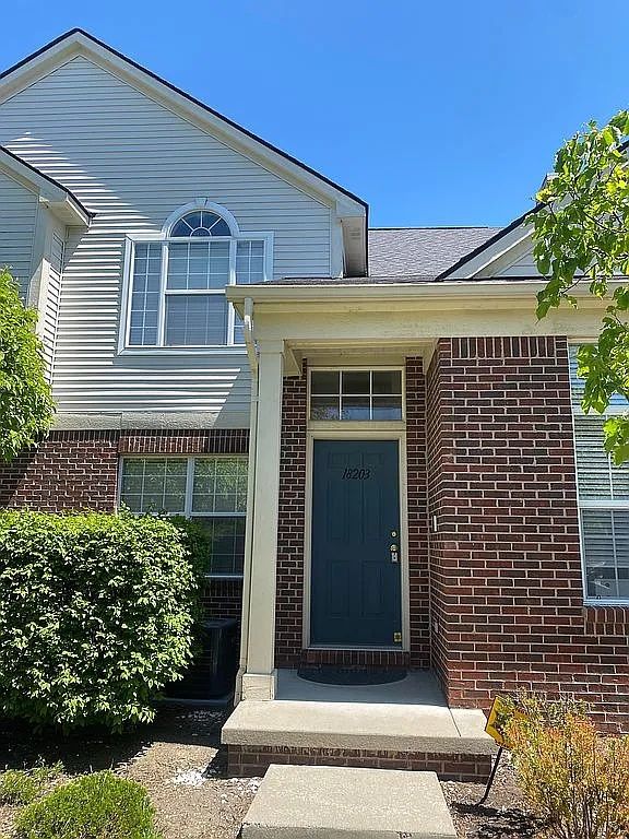 18203 Adri Cir, Walled Lake, MI 48390 - view of exterior entry with brick siding