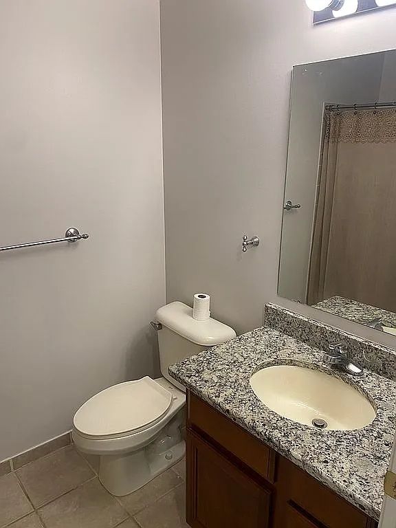 18203 Adri Cir, Walled Lake, MI 48390 - bathroom featuring tile patterned flooring, toilet, and vanity