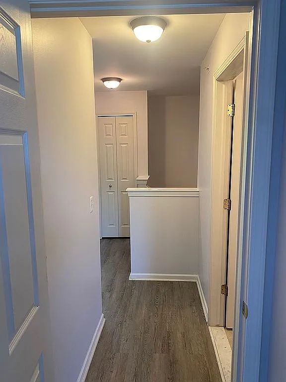 18203 Adri Cir, Walled Lake, MI 48390 - hall with wood finished floors and baseboards